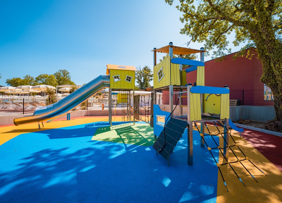 Bunter Kinderspielplatz mit Klettergerüsten und Rutschen im Aminess Style Camping Atea Resort.