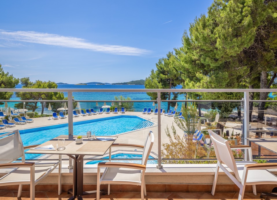 Restaurant terrace at Aminess Vival Grand Azur Hotel overlooking the pool and sea.