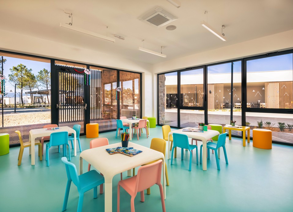 A space with colorful chairs and tables for children at Aminess Style Camping Avalona resort.