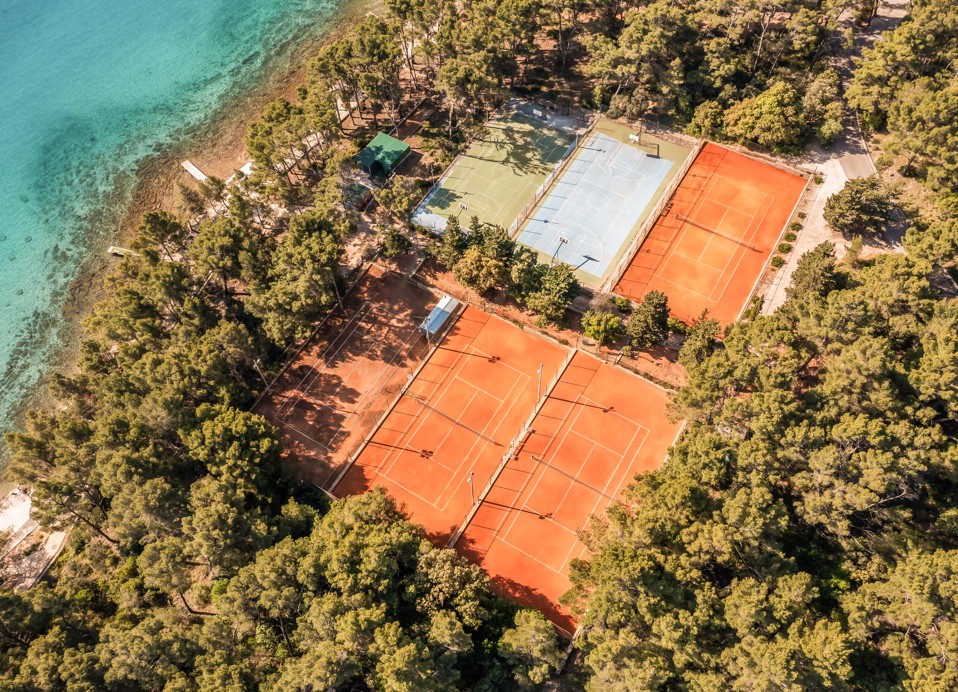Aerial view of seaside tennis courts at Aminess Younique Senses Resort on Hvar Island