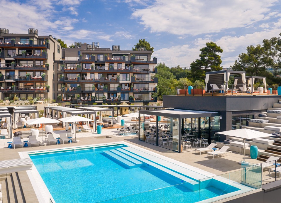Elevated view of the outdoor pool and buildings of Aminess Younique Vollo Hotel Residences
