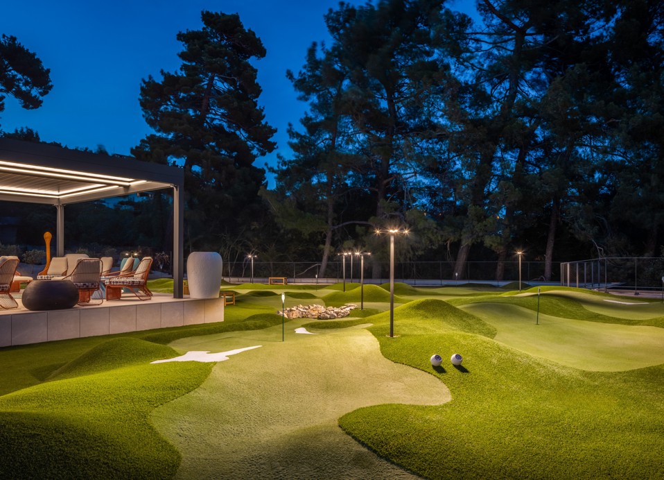 Illuminated mini golf course in the evening at Aminess Younique Vollo Hotel Residences