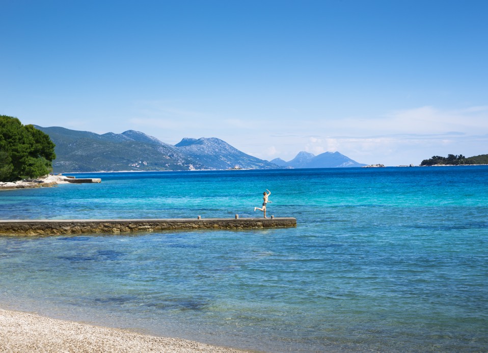 A peaceful pebble beach next to Aminess Maradiso Bellevue Village.