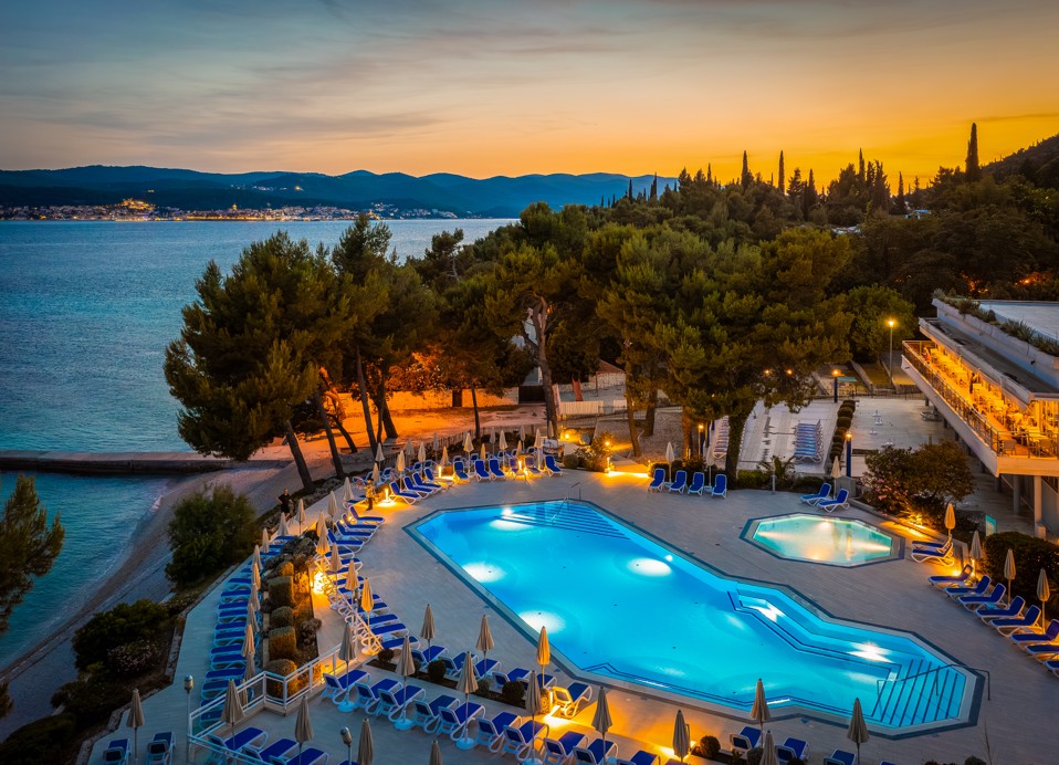 Beleuchteter Poolbereich, der eine magische nächtliche Atmosphäre im Aminess Vival Grand Azur Hotel in Orebic schafft.
