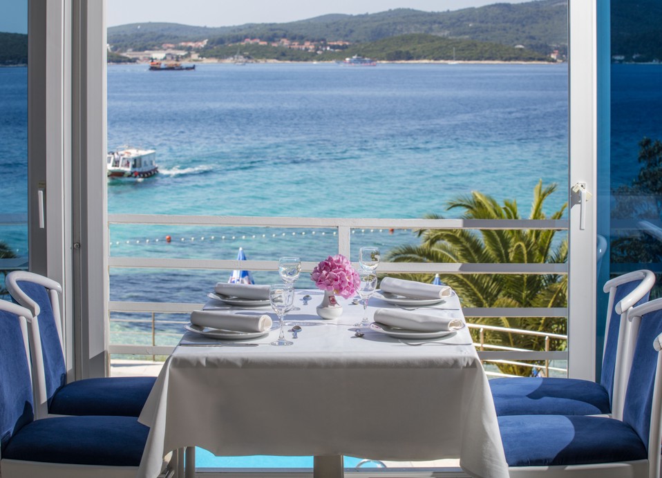 A bright and classic restaurant interior with a stunning sea views at Maradiso Orsan by Aminess Hotel  on Peljesac peninsula in Croatia.