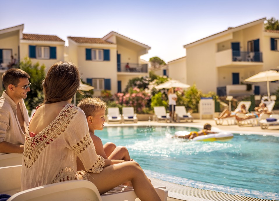 Famiglia che prende il sole in piscina vicino a Port9 Camping Holiday Homes di Aminess a Korcula.
