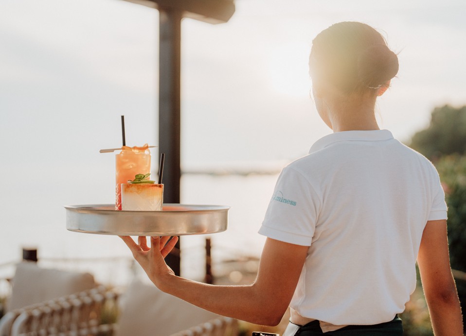 Oleandar bar waitress serving cocktails at Aminess Planet Camping Sirena, Novigrad, Croatia