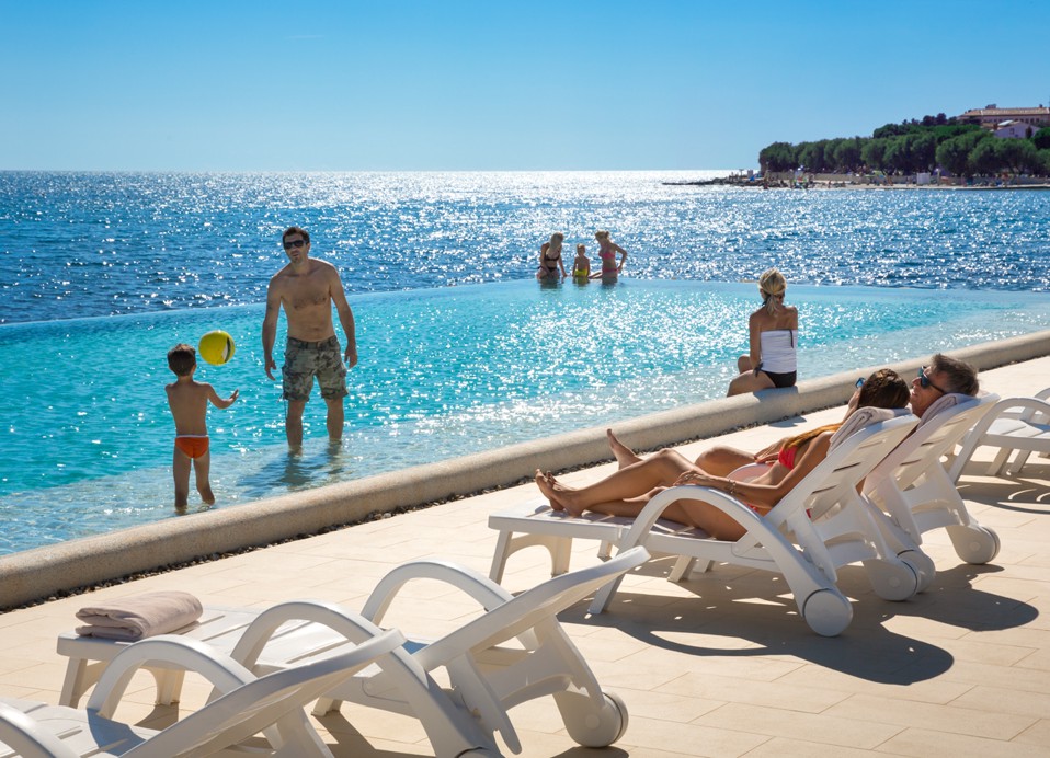 Family at the pool with sun loungers at Aminess Maradiso Hotel Laguna, Novigrad