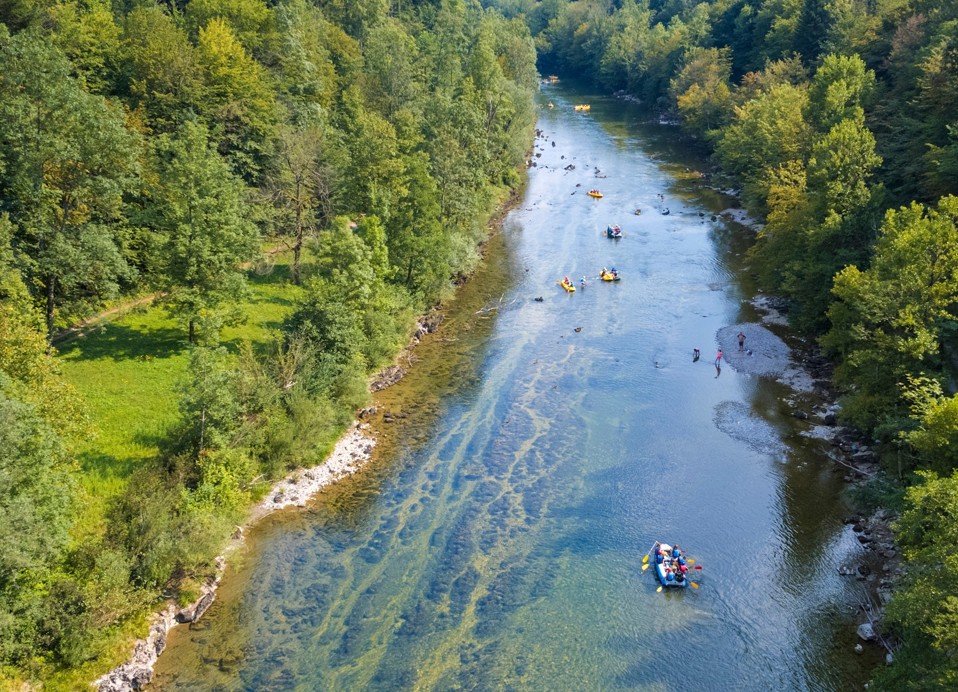 Rafting on the Kupa River surrounded by dense green forest near Karlovac.