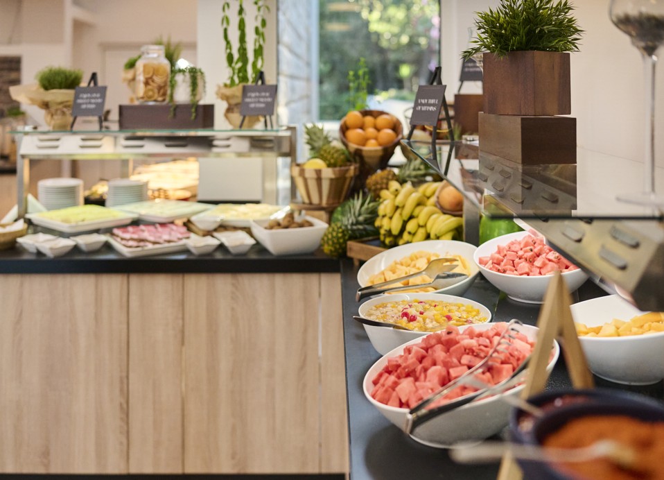 Close-up view of colorful buffet offerings at Restaurant Rondela, including tropical fruits, salads, and decorative elements at Aminess Maradiso Casa Bellevue.