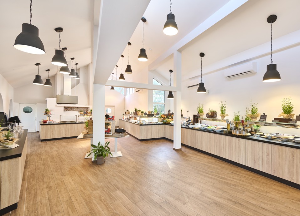 Sleek and modern interior of Restaurant Rondela, with well-lit buffet counters, high ceilings, and elegant decor at Aminess Maradiso Casa Bellevue.