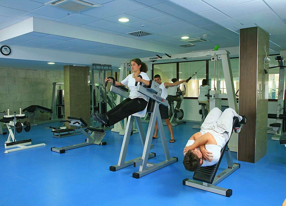 A fully equipped gym with modern exercise machines and free weights, accommodating guests focused on maintaining their fitness routines at the Maradiso Marko Polo by Aminess.
