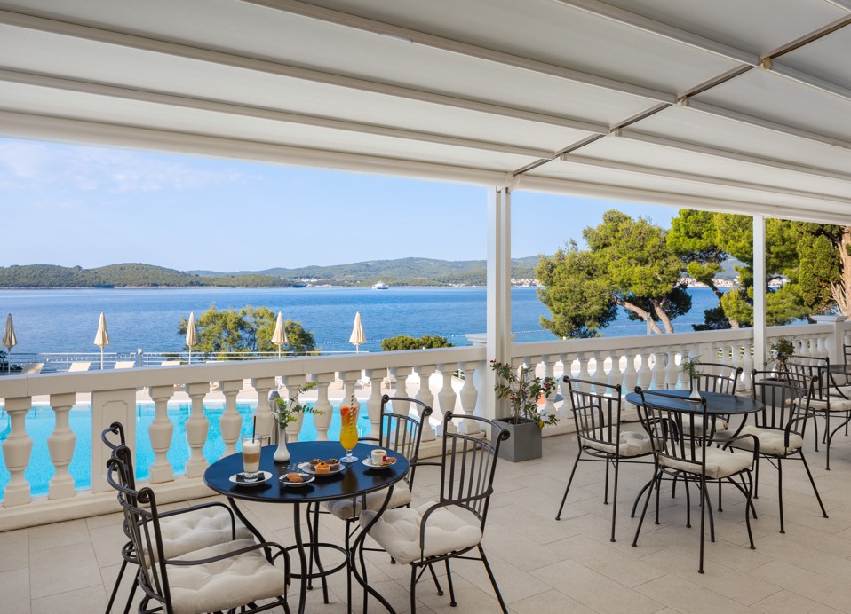 Bar Noir terrace at Younique Bellevue Hotel by Aminess with set tables and a sea view.