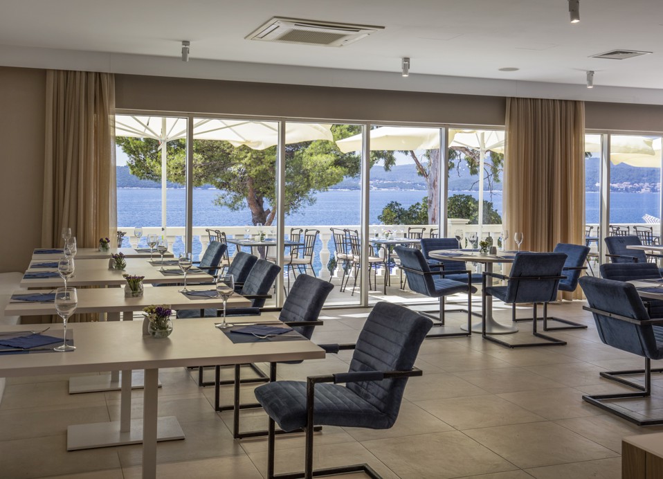 Elegant and modern interior seating are of at Aminess Younique Bellevue Hotel restaurant.