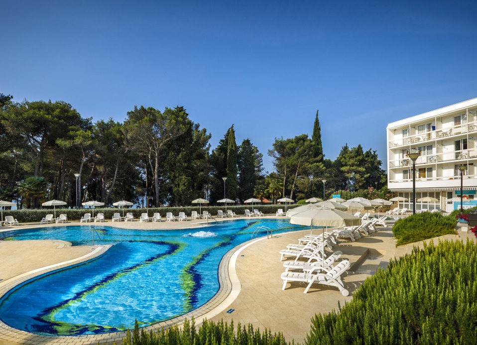 Outdoor pool with sun loungers at Aminess Maradiso Hotel Laguna, Novigrad