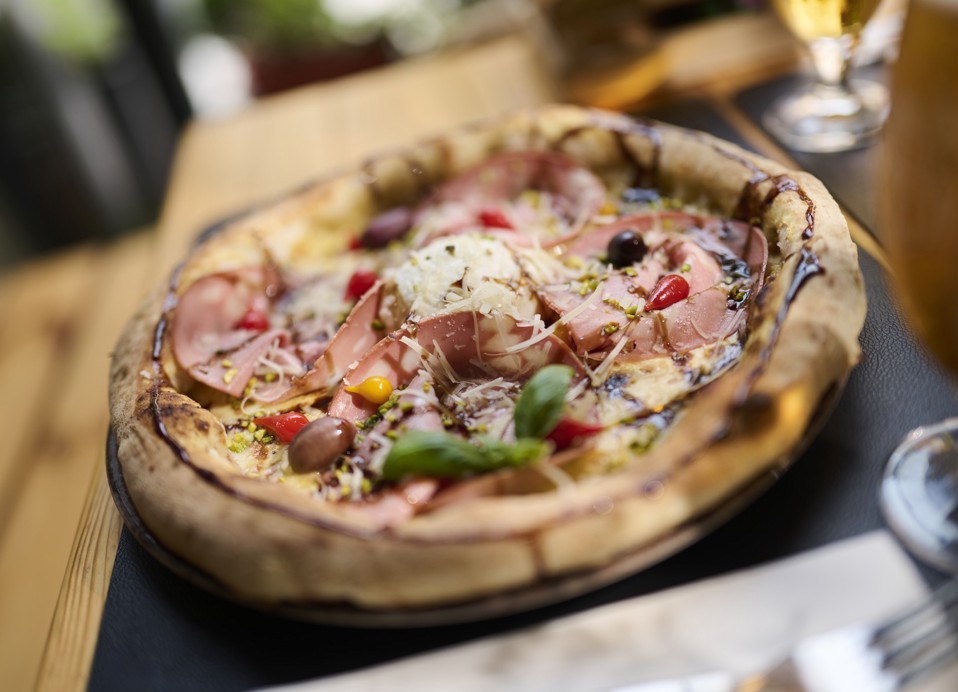 Pizza with mortadella, cheese, olives and basil at Aminess Kadoor Hotel.