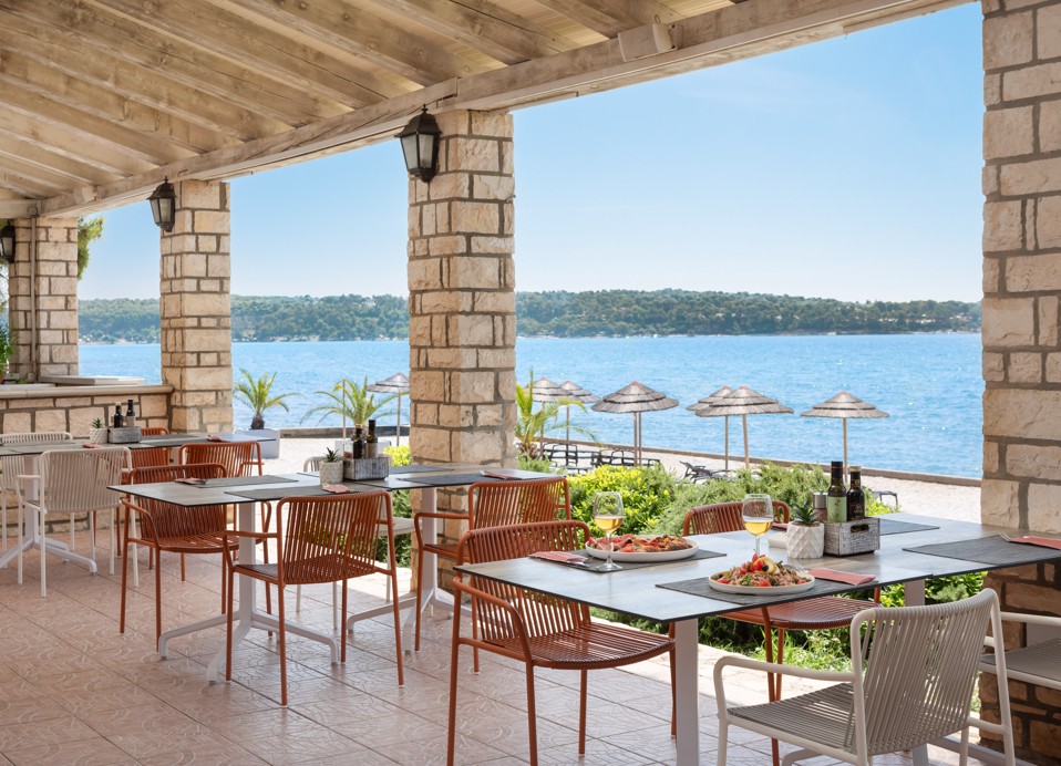 Tafels met uitzicht op zee in het La Gradella restaurant.