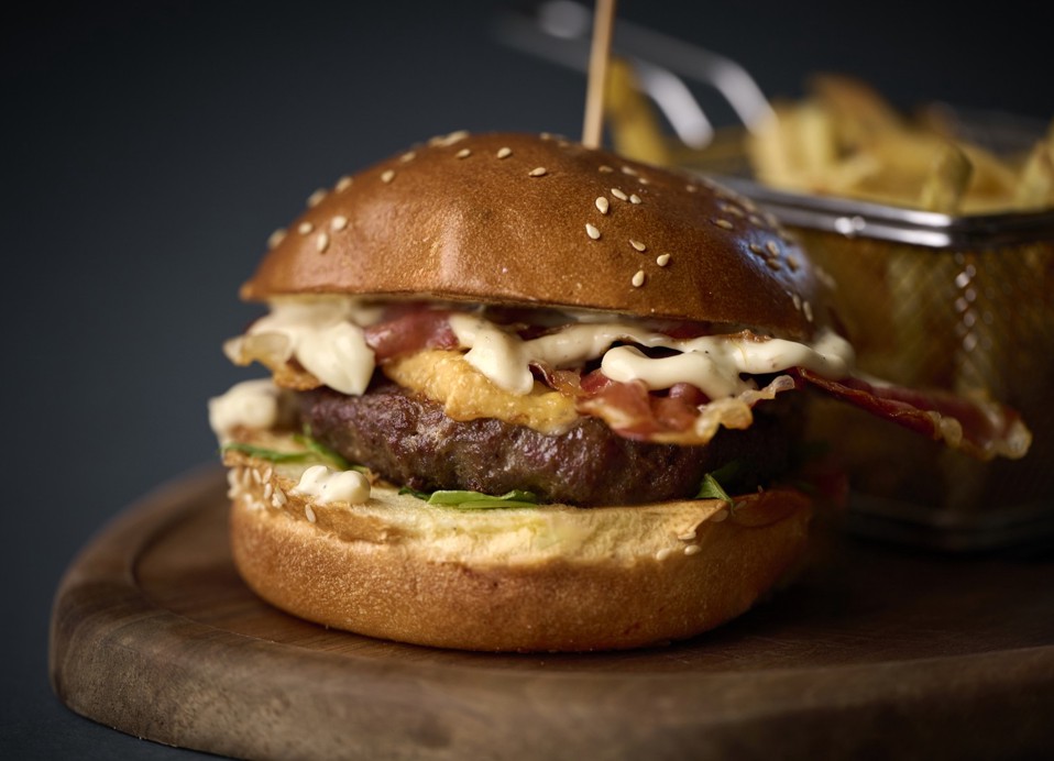 Burger with bacon, cheese and fries at Kadoor Restaurant in Karlovac.
