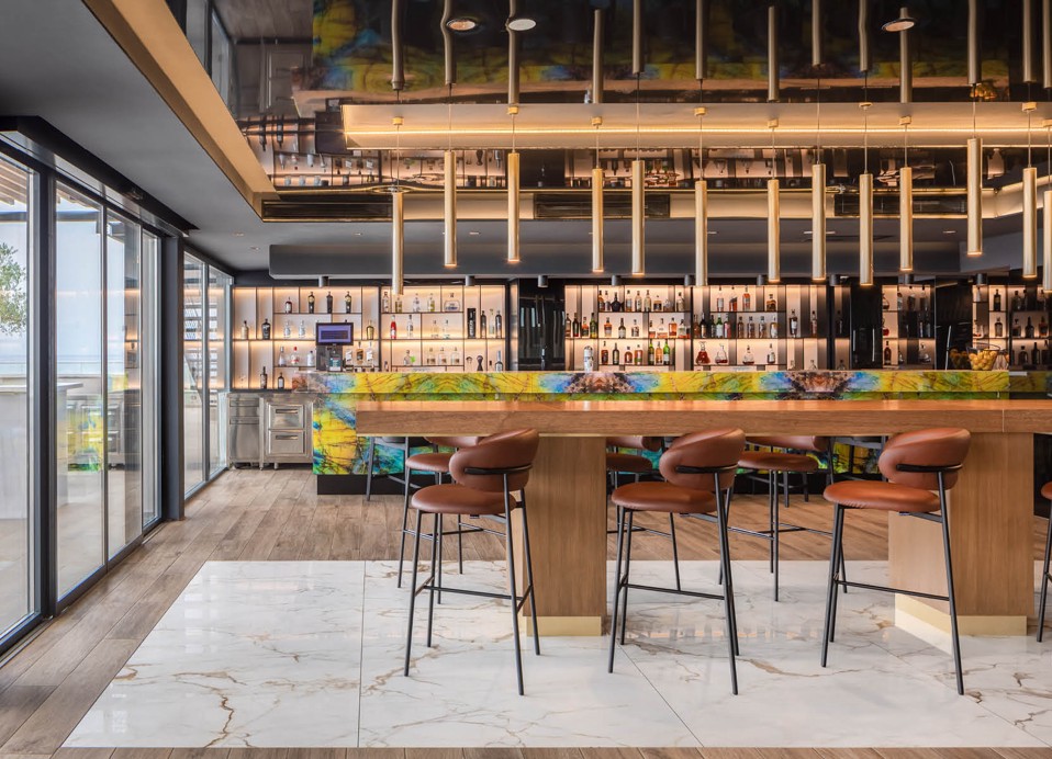 The inner part of the restaurant shows a large table and bar at Aminess Laurel Khalani hotel.