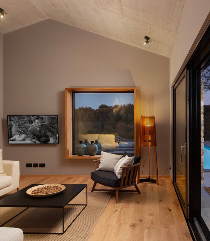 An elegant living room with direct access to the patio and heated pool